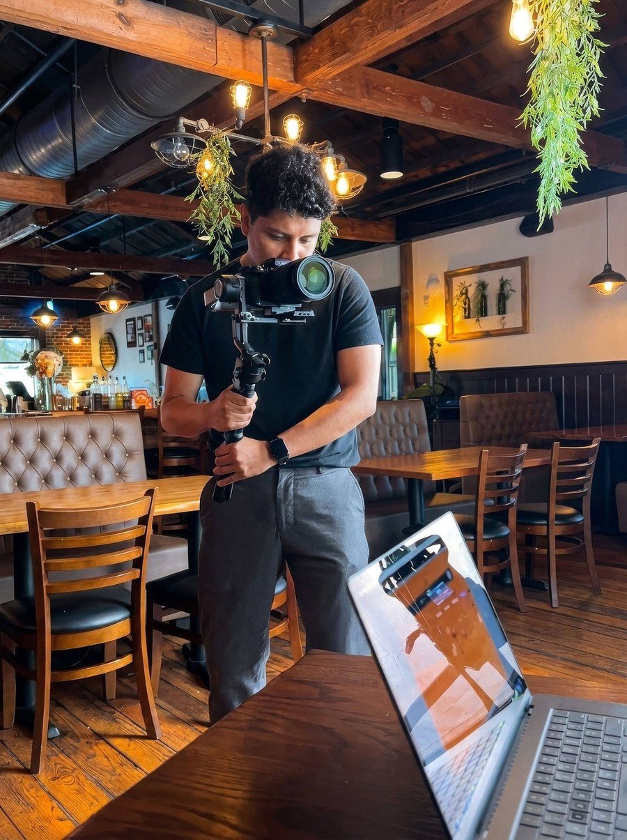 Fel filming a small business with a camera gimbal on location